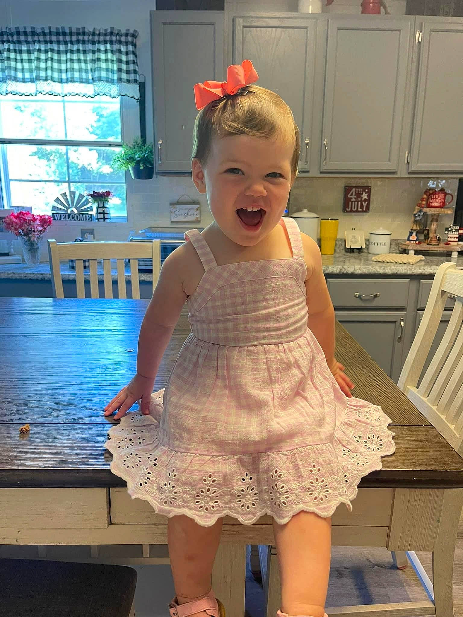 Isla joined the competition — help win amazing prizes! baby_toddler_clothing, cabinetry, day_dress, drawer, dress, embellishment, flooring, hairstyle, happy, home_appliance, joint, kitchen, kitchen_appliance, one_piece_garment, person, sleeve, smile, standing, toddler, waist