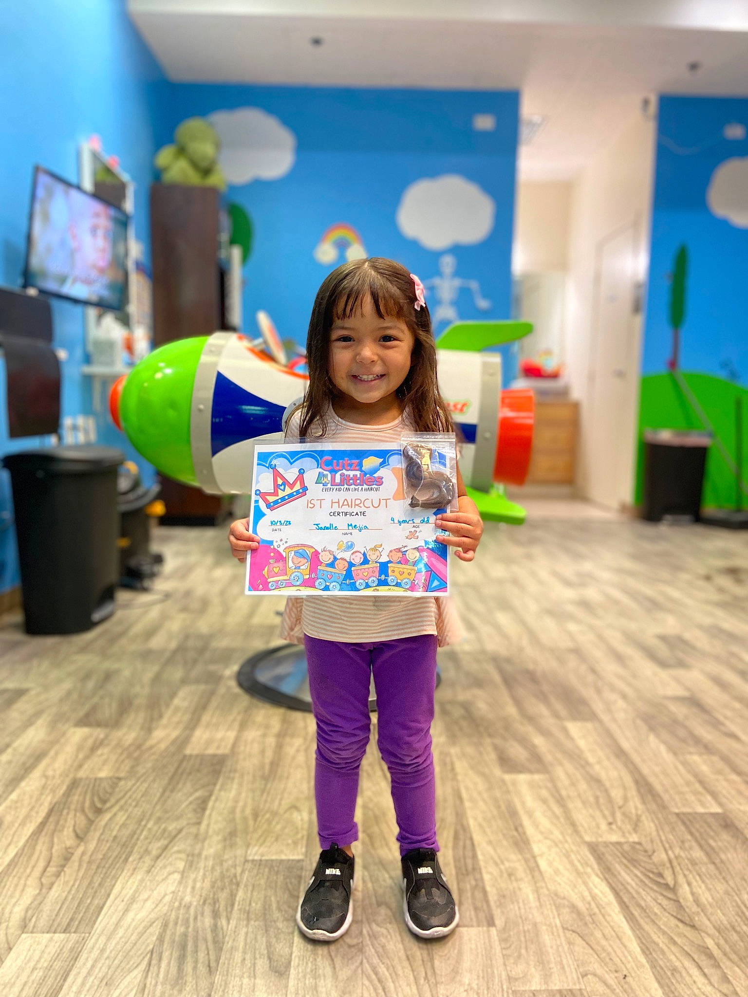 Janelle is registered to the contest to win money with this photo: balloon, boot, child, computer_monitor, event, flooring, fun, happy, joy, kindergarten, leisure, party, party_supply, person, play, recreation, room, smile, sock, t_shirt