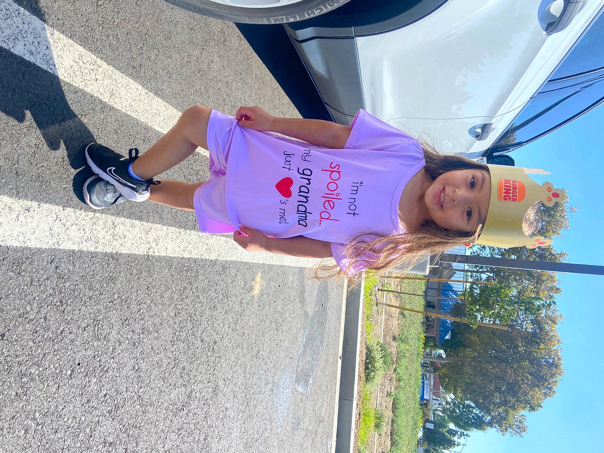 Janelle is registered to the contest to win money with this photo: asphalt, blue, calf, electric_blue, foot, fun, hat, headwear, human_leg, joy, leg, leisure, magenta, person, pink, shorts, sky, t_shirt, thigh, tire