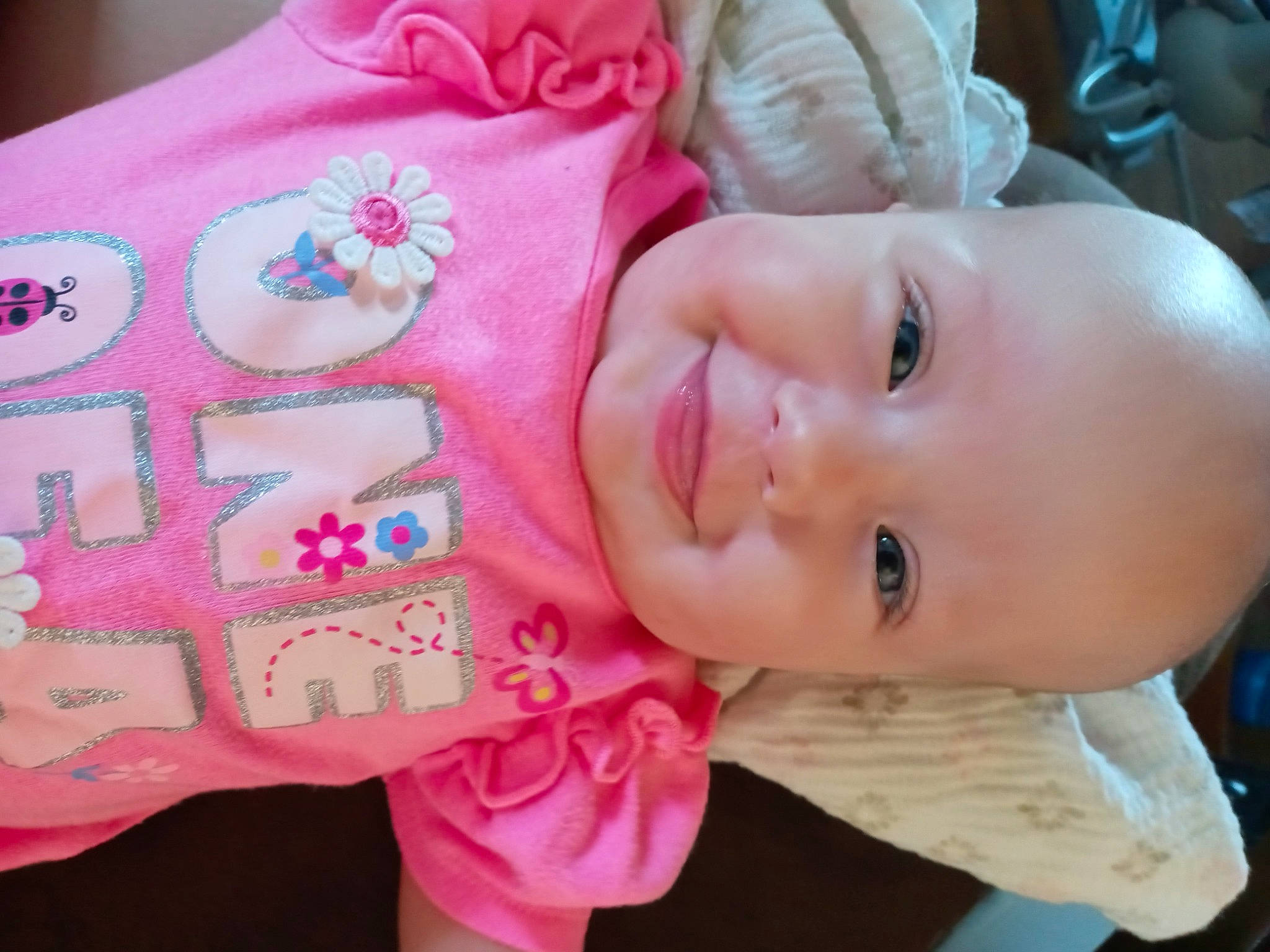 Anastasia is registered to the contest to win money with this photo: baby, baby_toddler_clothing, cheek, chin, facial_expression, finger, hand, happy, human_body, joy, lip, mammal, mouth, neck, nose, organ, person, pink, skin, sleeve