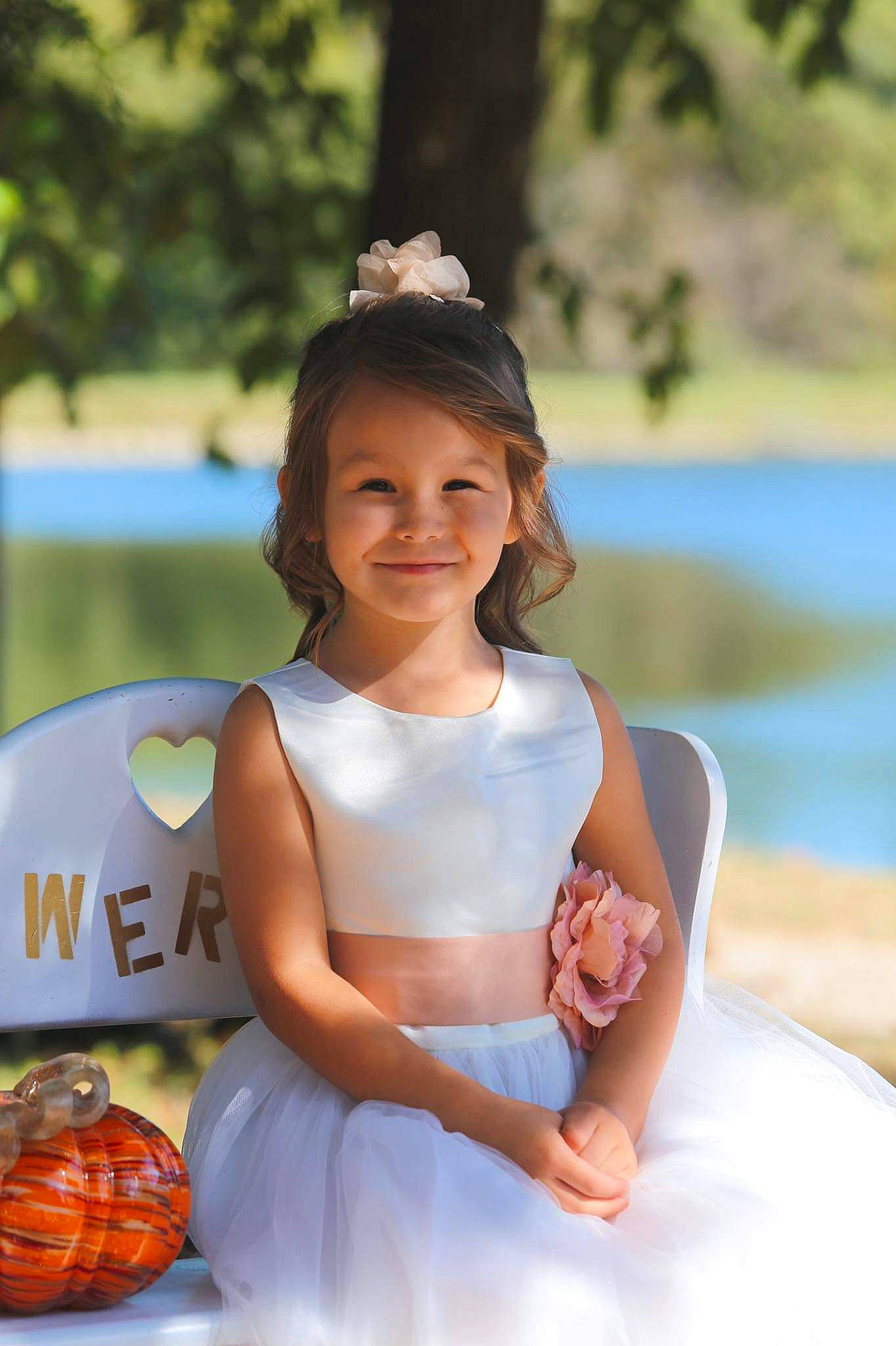 Jasmine is registered to the contest to win money with this photo: beauty, calabaza, child, dress, event, flash_photography, formal_wear, fun, grass, happy, joy, leisure, people_in_nature, person, plant, recreation, sitting, smile, toddler, tree