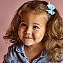 Isabella a rejoint le concours — aidez-le/la à gagner de superbes lots ! blue_bow, buttoned_shirt, child, childhood, closeup, curly_hair, cute, denim_shirt, face, fashion, girl, happy, indoor, innocence, person, pink_background, portrait, smile, warm_tones, young