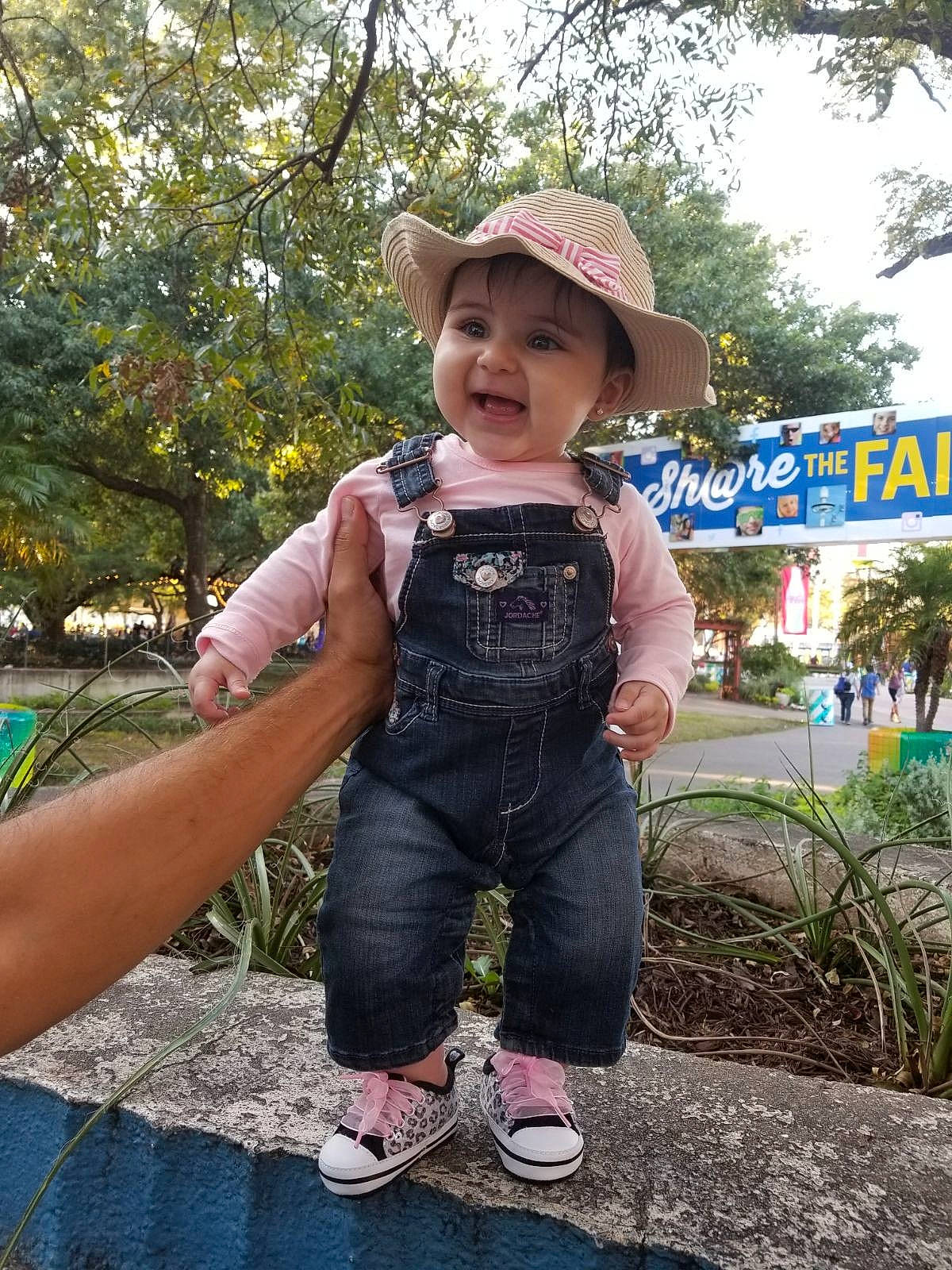 Celia joined the competition — help win amazing prizes! car, child, fun, headgear, headwear, jeans, person, product, recreation, toddler, travel, tree, vacation