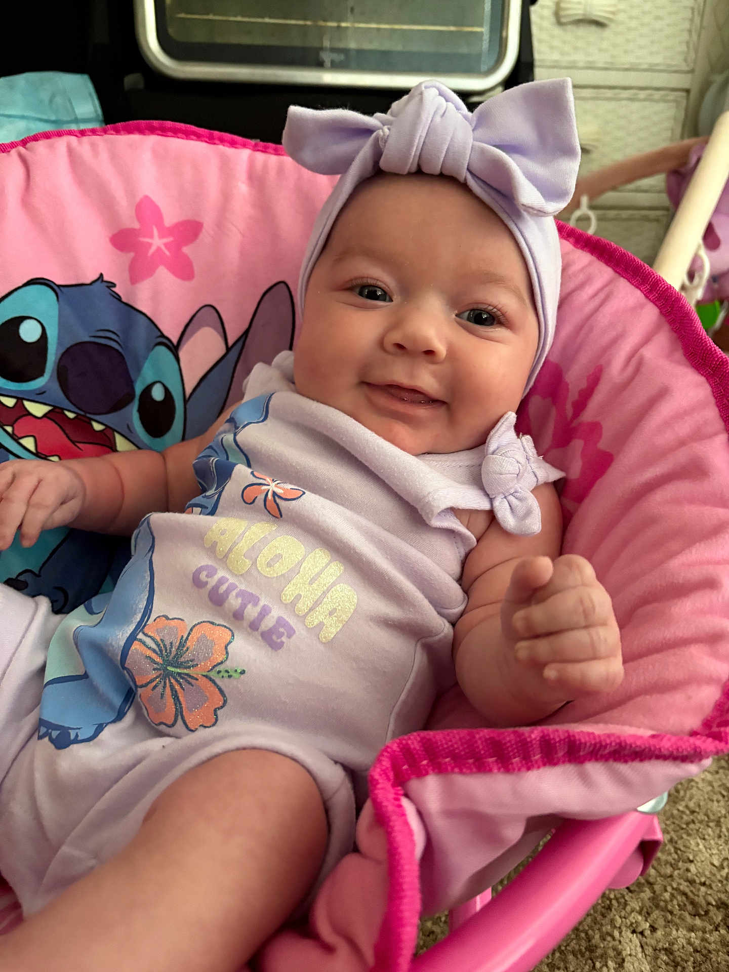 Willow joined the competition — help win amazing prizes! baby, child, smiling, pink, headband, bow, onesie, aloha, cutie, stitch, character, chair, indoor, cute, infant, happy, portrait, clothing, hand, face
