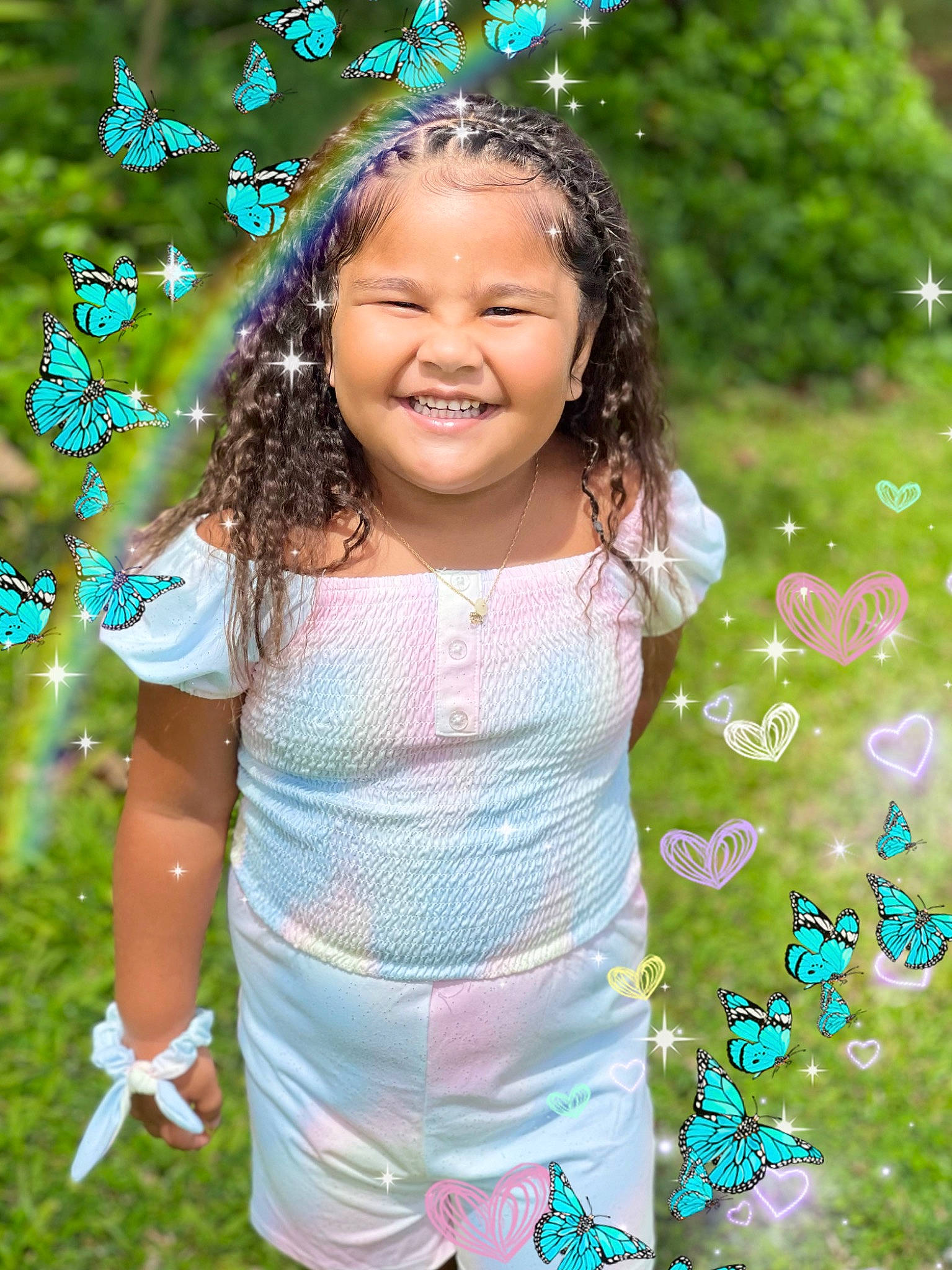 Kailea Palenapa Likelio is registered to the contest to win money with this photo: baby_toddler_clothing, botany, clothing, facial_expression, fun, gesture, grass, green, happy, headpiece, jewellery, joy, meadow, nature, pattern, people_in_nature, person, plant, sleeve, smile