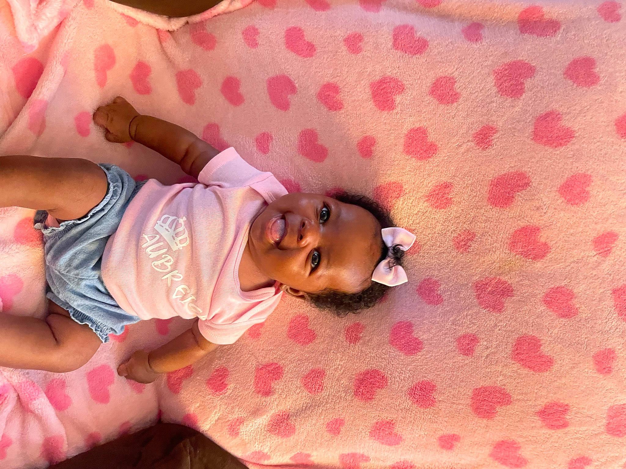 Aubreigh joined the competition — help win amazing prizes! abdomen, baby, baby_toddler_clothing, child, comfort, facial_expression, glasses, happy, head, human_body, linens, magenta, pattern, person, pink, product, skin, sleeve, textile, thigh
