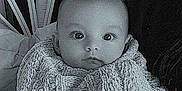 Lucymae is registered to the contest to win money with this photo: baby, infant, blanket, knit, wicker_chair, indoor, portrait, child, cute, face, curious, seated, cozy, monochrome, black_and_white, young, person, warm, texture, soft