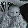baby, infant, blanket, knit, wicker_chair, indoor, portrait, child, cute, face, curious, seated, cozy, monochrome, black_and_white, young, person, warm, texture, soft