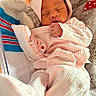 newborn, baby, sleeping, pink_clothing, hat, blanket, plush_toy, cozy, indoors, infant, peaceful, cute, child, soft, resting, wrapped, small_hands, portrait, warm, cute_outfit