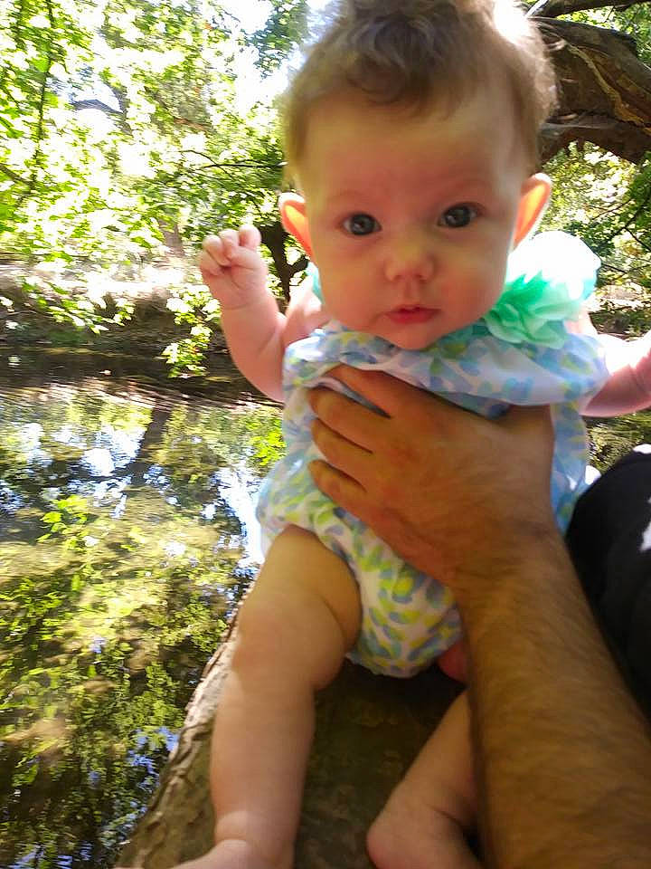 Cordelia is registered to the contest to win money with this photo: abdomen, child, fun, infant, person, play, toddler, tree, trunk, vacation