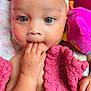baby, child, blue_eyes, headband, bow, blanket, pink_blanket, hand, fingers, plush_toy, bird_toy, face, portrait, cute, infant, closeup, indoors, soft_toy, sleeping_area, cozy