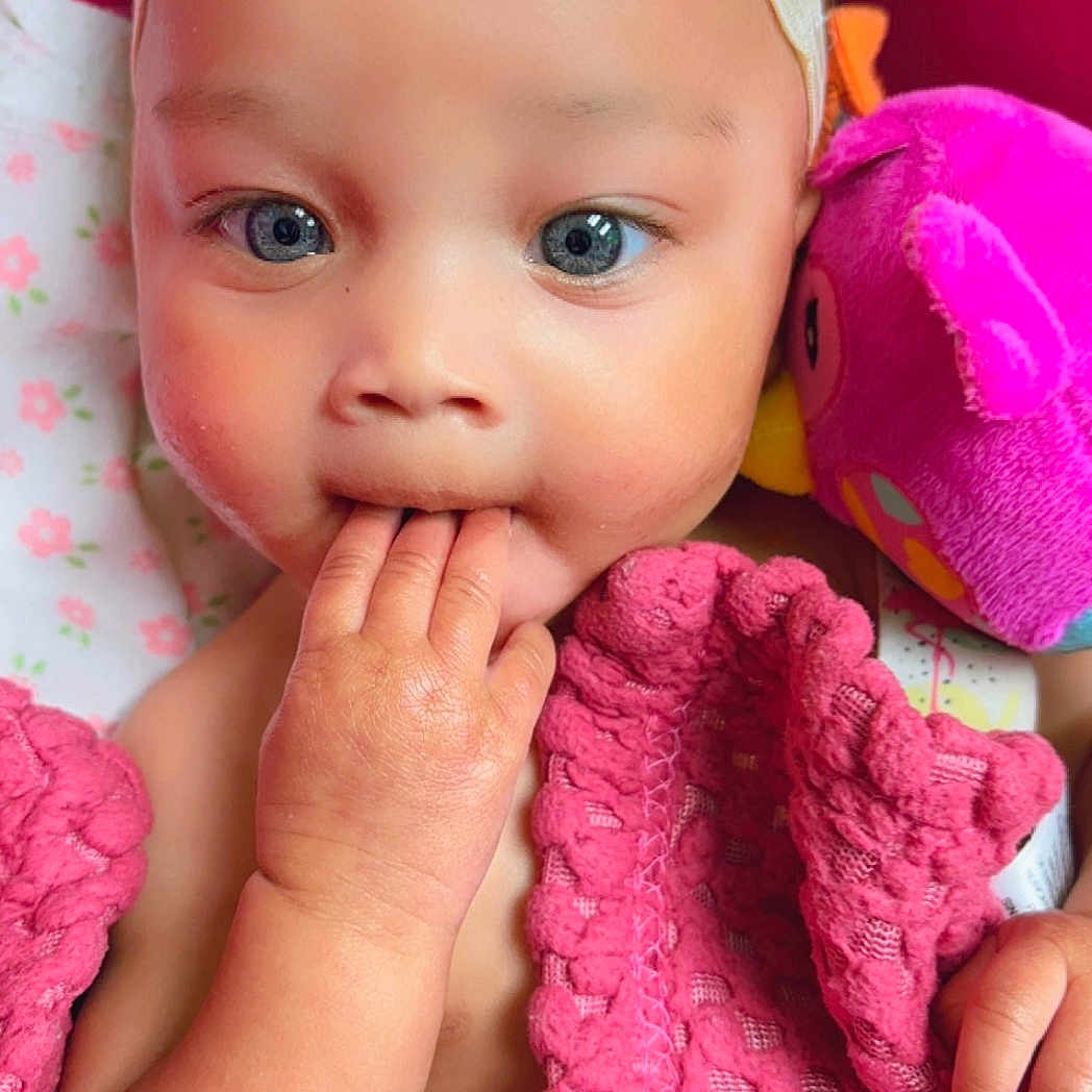 Kayora joined the competition — help win amazing prizes! baby, bird_toy, blanket, blue_eyes, bow, child, closeup, cozy, cute, face, fingers, hand, headband, indoors, infant, pink_blanket, plush_toy, portrait, sleeping_area, soft_toy