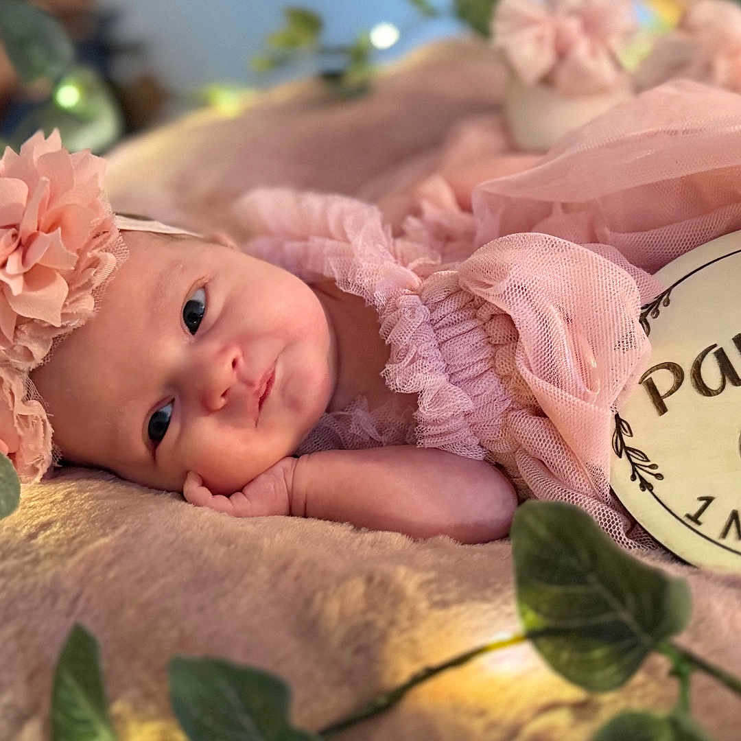 Paisley joined the competition — help win amazing prizes! baby, blanket, bonnet, cap, clothing, face, flower, flowerarrangement, flowerbouquet, hat, head, leaf, newborn, person, petal, photography, plant, portrait, quilt, rose