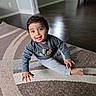 baby, carpet, casual_wear, child, clothing, crawling, cute, floor, hand, happy, home, indoor, patterned_rug, person, playful, portrait, sitting, smiling, toddler, young_child