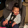 baby, car_interior, car_seat, child, clothing, cute, funny_expression, hair_up, indoor, person, pink_shoe, playful, safety_harness, seat, seatbelt, sitting, smiling, toddler, tongue_out, young_child