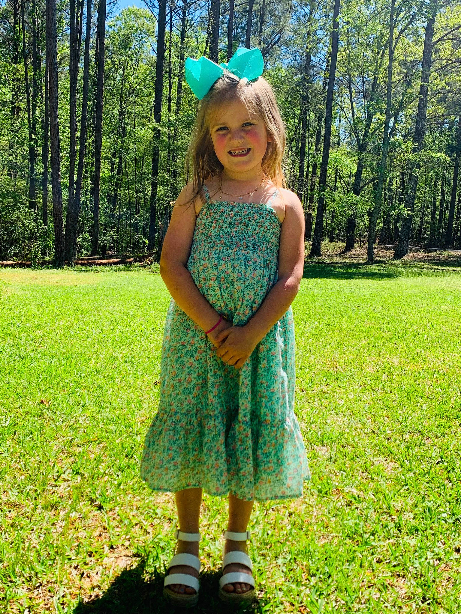 Maggie is registered to the contest to win money with this photo: baby_toddler_clothing, cap, day_dress, dress, electric_blue, grass, grassland, green, hairstyle, happy, hat, joy, meadow, one_piece_garment, people_in_nature, person, plant, sky, smile, summer
