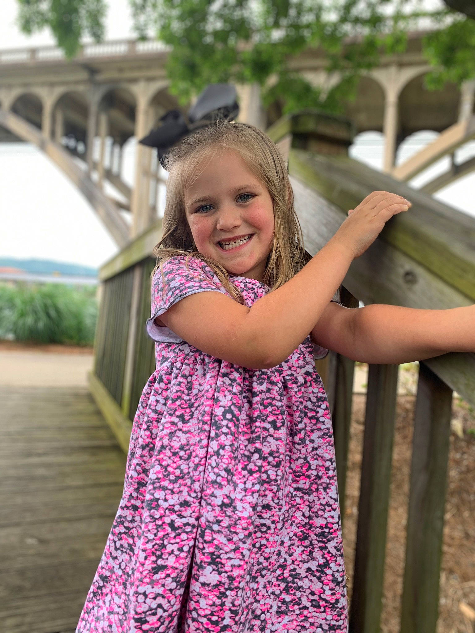Maggie is registered to the contest to win money with this photo: blond, day_dress, dress, fun, grass, happy, joy, leisure, long_hair, magenta, pattern, people_in_nature, person, pink, plant, recreation, skin, smile, toddler, tree