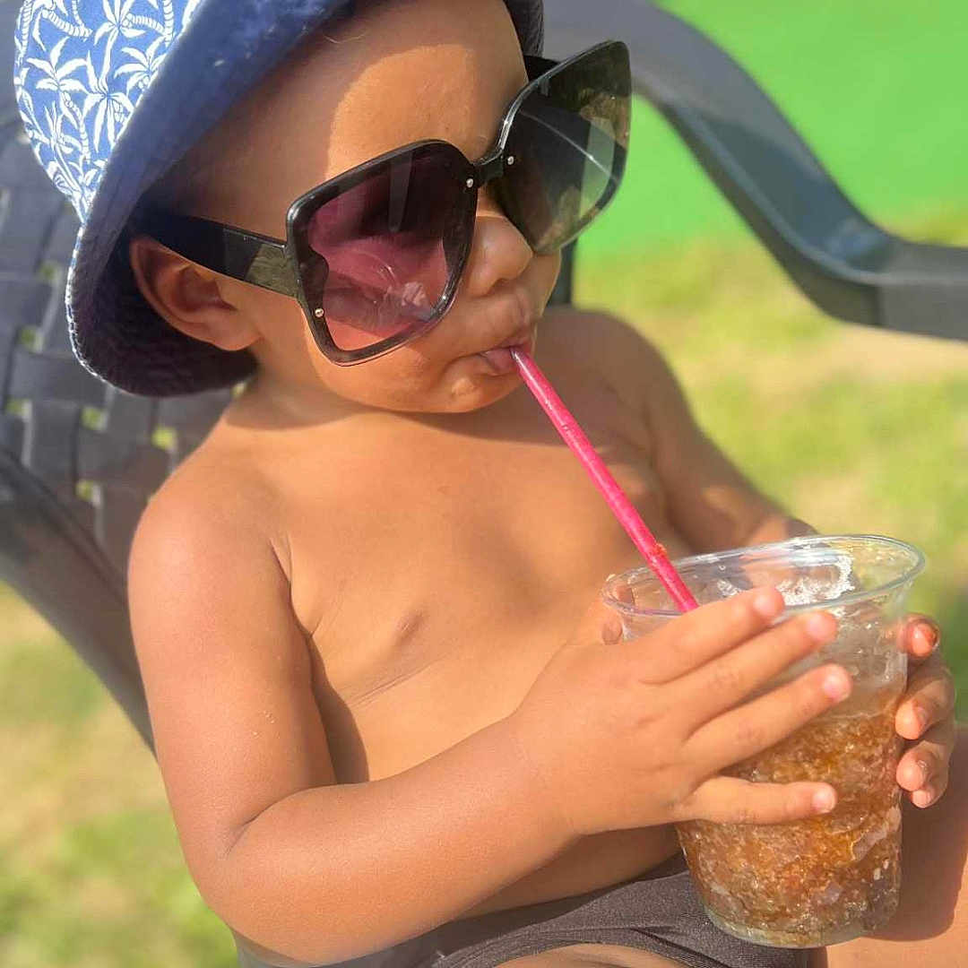 Kassym a rejoint le concours — aidez-le/la à gagner de superbes lots ! backyard, bare_torso, bucket_hat, chair, child, drink, grass, hat, legs, outdoor, plastic_cup, portrait, relaxing, straw, summer, sunglasses, sunny, swimwear, toddler, vacation