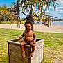 Kassym a rejoint le concours — aidez-le/la à gagner de superbes lots ! child, toddler, smile, palm_tree, planter, wooden_box, beach, sand, grass, lake, outdoors, portrait, happy_child, bare_chest, toes, vacation, summer, nature, greenery, playful