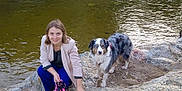 Gypsie a rejoint le concours — aidez-le/la à gagner de superbes lots ! woman, dog, australian_shepherd, river, rock, water, leash, outdoor, pet, nature, animal, person, smile, casual_clothing, wet_dog, daylight, crouching, looking_at_camera, scenic, relaxed