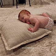 Ashton joined the competition — help win amazing prizes! baby, child, infant, diaper, cushion, carpet, floor, indoor, kitchen, stool, appliance, smiling, red_hair, relaxed, lying_down, home, soft_lighting, text_overlay, cozy, wood_floor