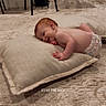 baby, child, infant, diaper, cushion, carpet, floor, indoor, kitchen, stool, appliance, smiling, red_hair, relaxed, lying_down, home, soft_lighting, text_overlay, cozy, wood_floor