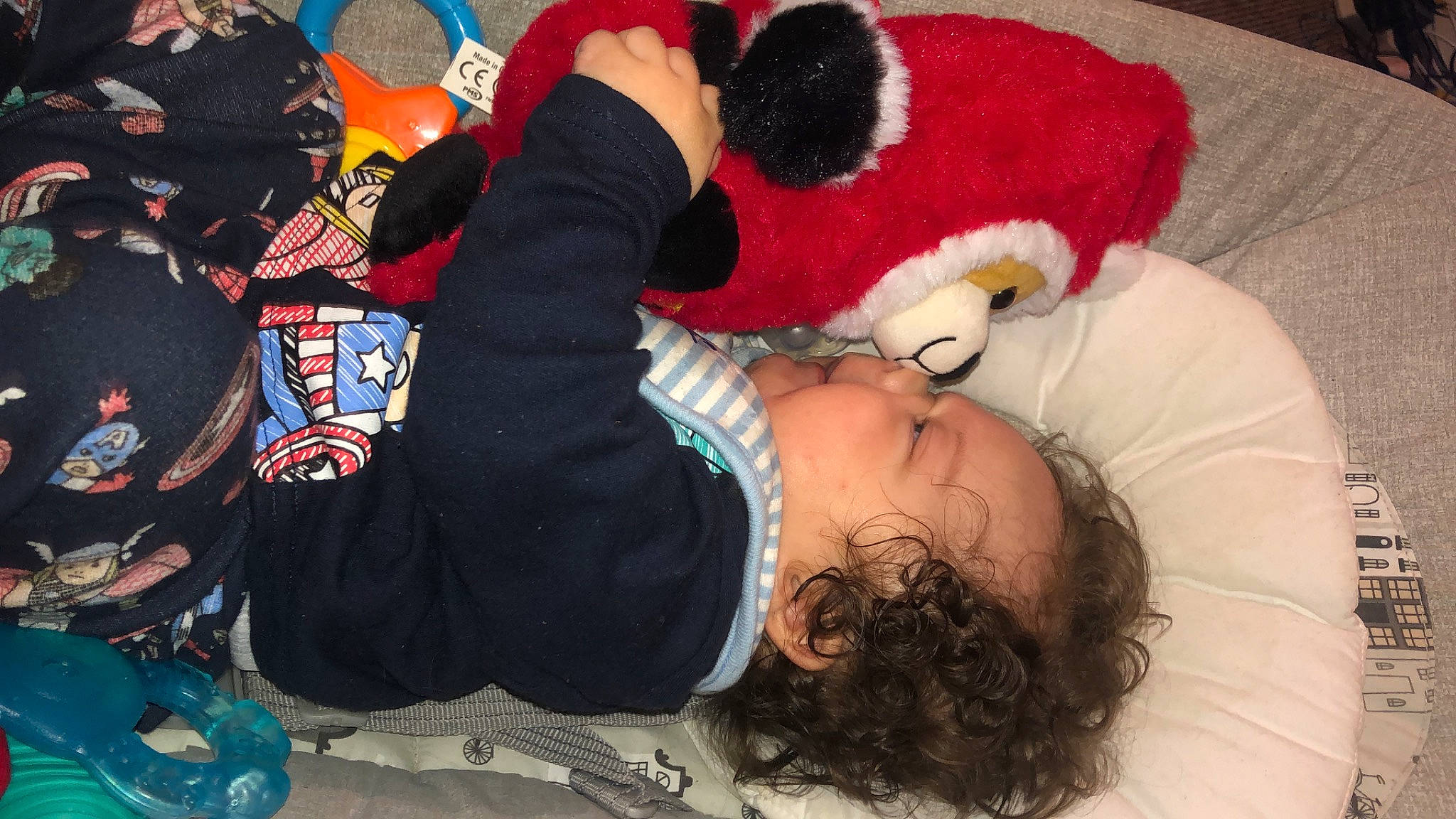 Riley is registered to the contest to win money with this photo: cap, carmine, child, costume, event, fictional_character, flooring, fun, fur, hat, headgear, lap, mammal, mascot, pattern, person, plush, stuffed_toy, teddy_bear, toy