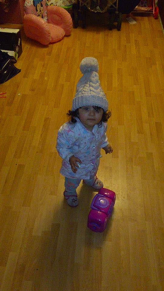 Mya is registered to the contest to win money with this photo: baby, baby_toddler_clothing, child, electric_blue, floor, flooring, fun, hardwood, headwear, laminate_flooring, person, riding_toy, room, sitting, skin, toddler, toy, varnish, wheel, wood