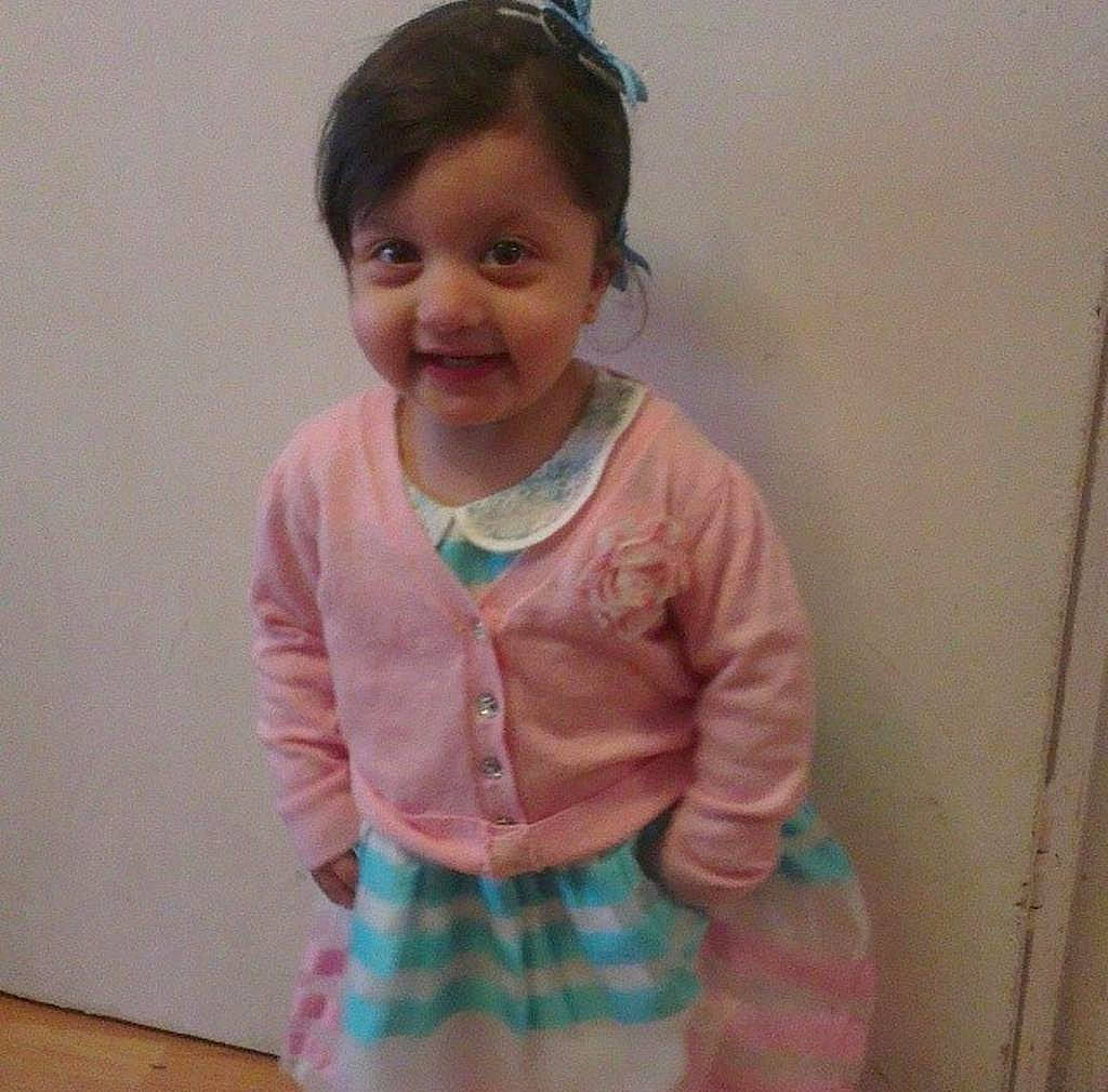 Mya is registered to the contest to win money with this photo: baby_toddler_clothing, cheek, dress, face, gesture, goggles, hair, happy, head, iris, joy, neck, outerwear, person, pink, shoulder, skin, sleeve, smile, t_shirt