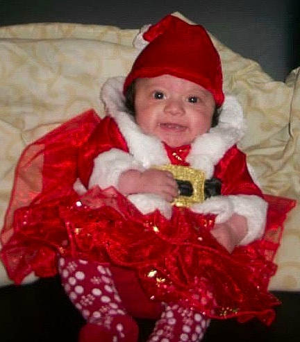 Mya joined the competition — help win amazing prizes! baby, baby_toddler_clothing, cap, christmas, comfort, costume_hat, event, fur_clothing, happy, hat, headwear, holiday, human_body, lap, outerwear, person, santa_claus, sleeve, smile, textile