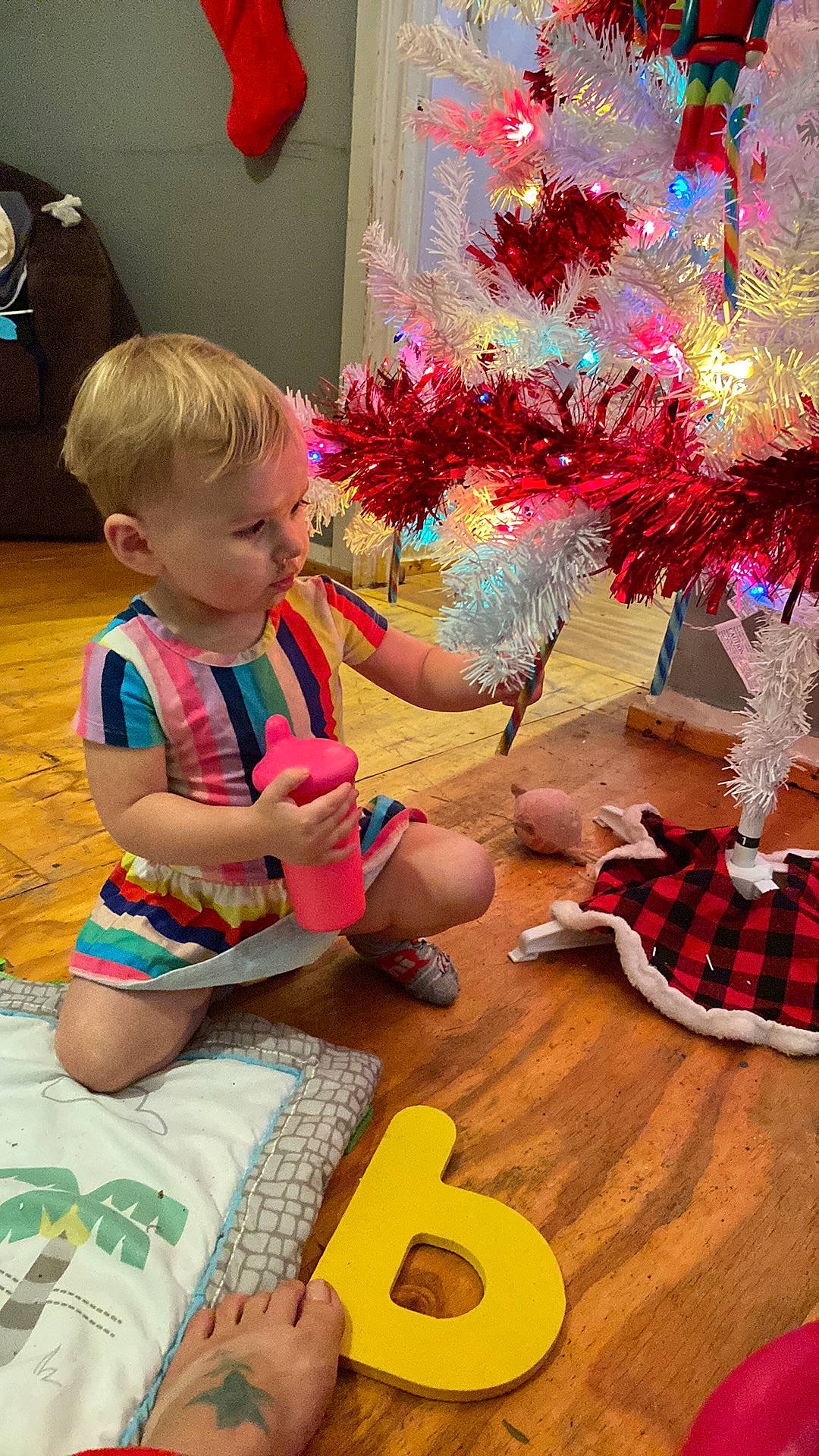 Gracelynn is registered to the contest to win money with this photo: art, baby, baby_toddler_clothing, child, design, event, fun, leisure, musical_instrument, person, photograph, plaid, plant, play, room, sitting, snapshot, tartan, toddler, tree