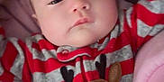 Sky is registered to the contest to win money with this photo: baby, infant, sleepy, onesie, red_stripes, gray_stripes, reindeer, plush, blanket, bed, cute, child, portrait, indoors, soft_texture, clothing, face, head, resting, young