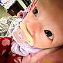 Sky is registered to the contest to win money with this photo: baby, pacifier, blanket, purple_clothing, indoor, closeup, face, infant, bed, comfort, soft, cute, sleepwear, child, person, portrait, resting, lying_down, young, warm