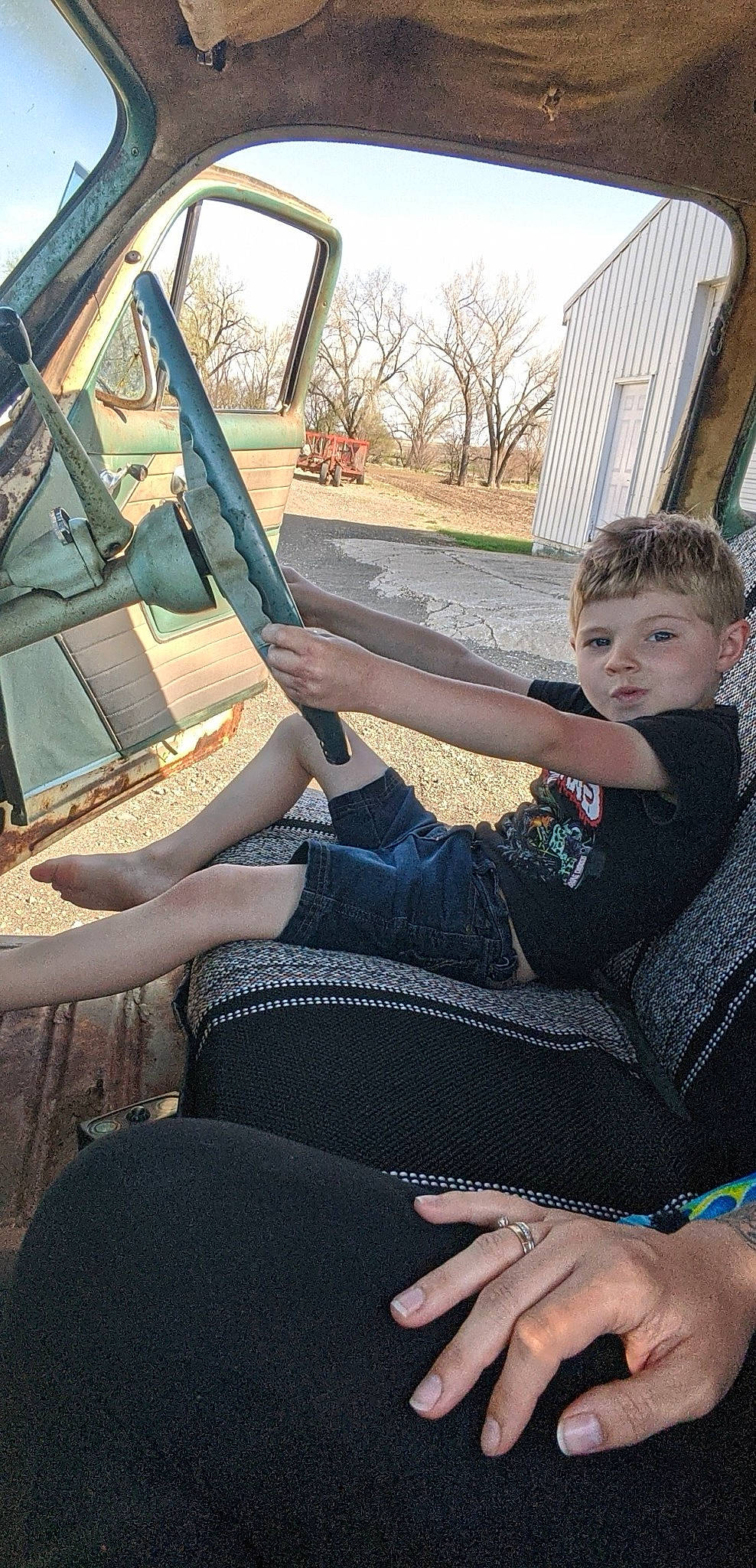 Collin is registered to the contest to win money with this photo: auto_part, automotive_window_part, car_seat, glass, hand, leg, person, sitting, vehicle, windshield