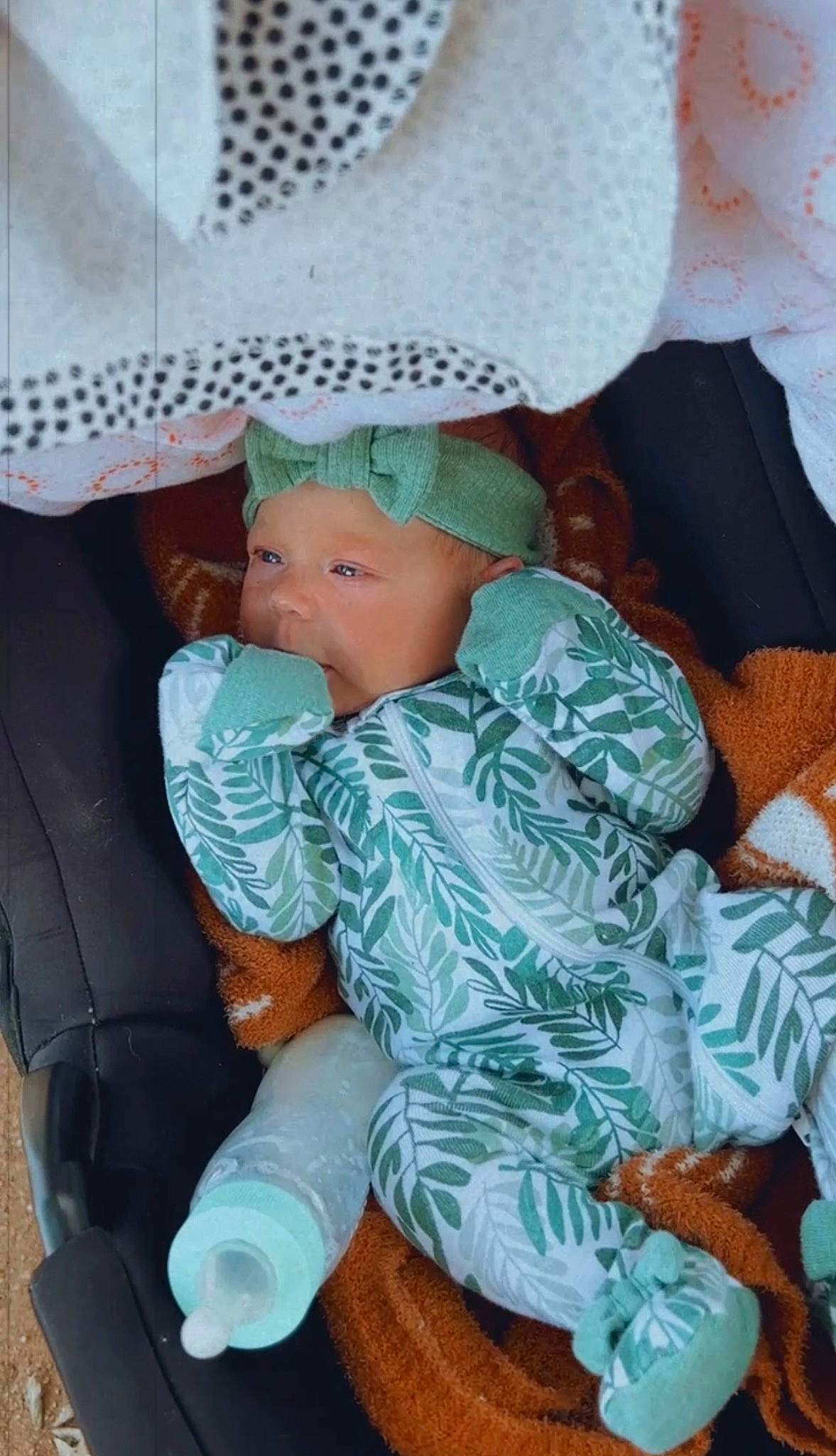 Ella is registered to the contest to win money with this photo: baby, baby_products, baby_toddler_clothing, car_seat, chair, child, comfort, eye, head, headwear, human_body, lap, linens, nap, pattern, person, sitting, sleep, textile, thigh