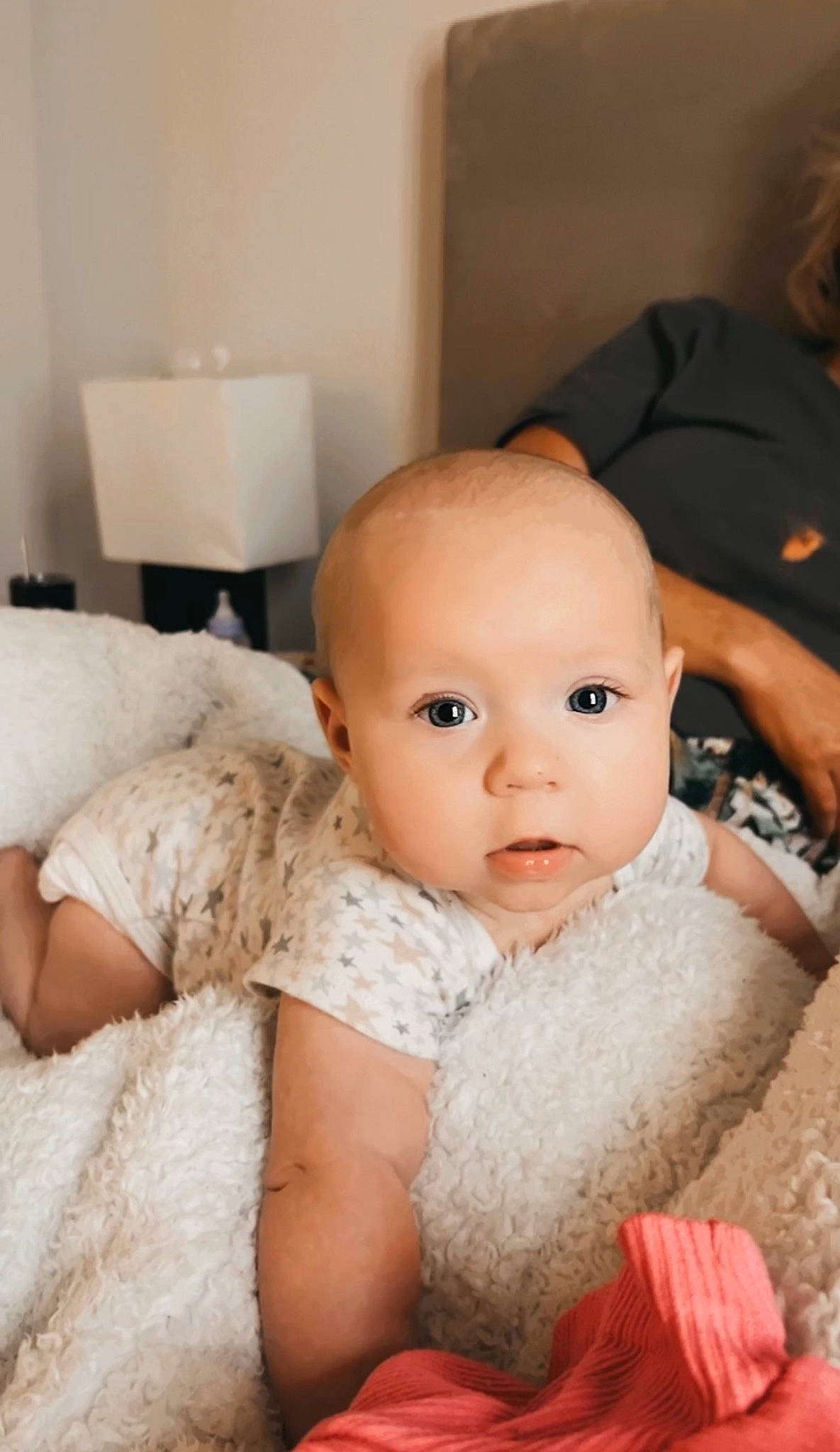 Ella is registered to the contest to win money with this photo: baby, baby_toddler_clothing, cheek, comfort, eyebrow, eyelash, finger, flash_photography, flooring, fur, happy, head, headgear, iris, linens, lip, person, sitting, skin, textile