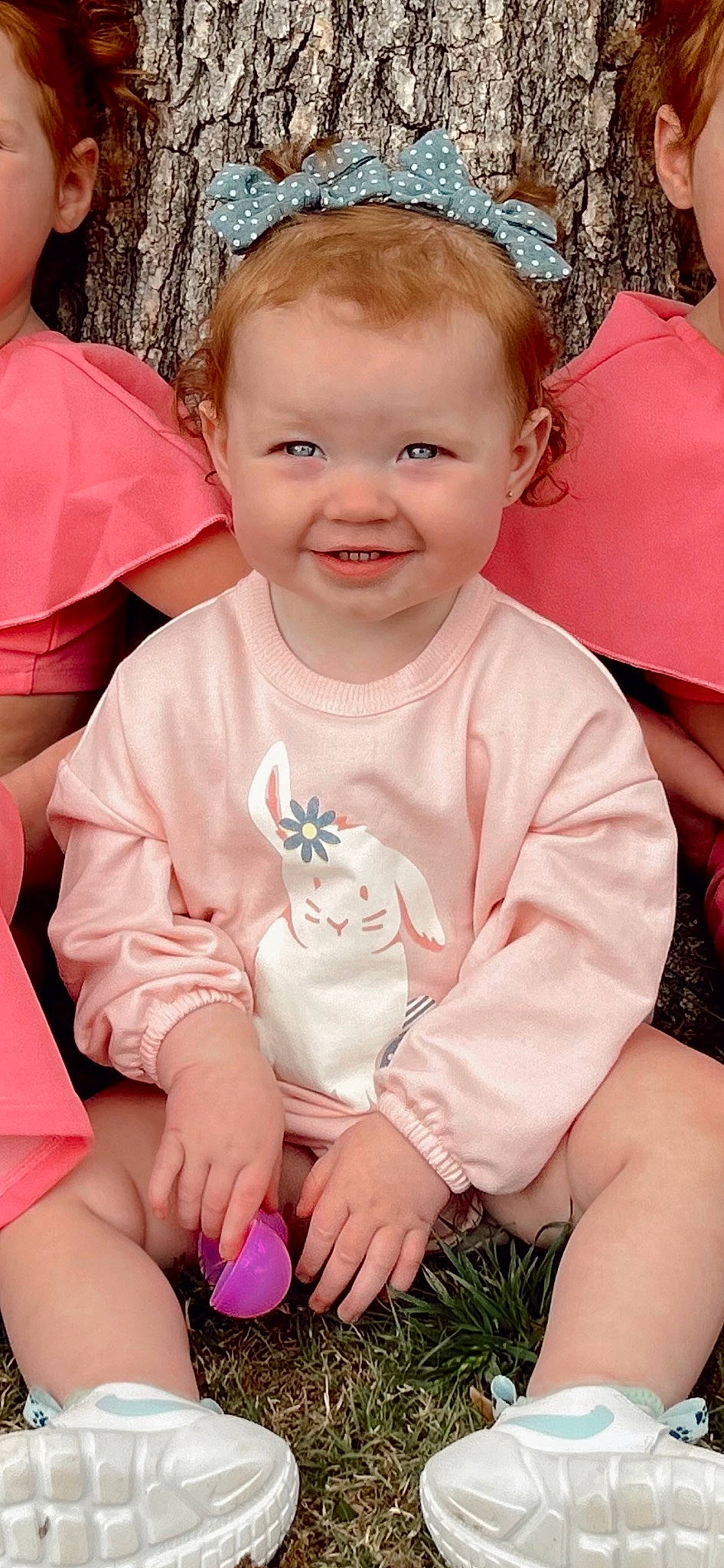 Scarlett is registered to the contest to win money with this photo: arm, baby, baby_toddler_clothing, cheek, child, chin, eye, facial_expression, finger, grass, happy, head, iris, joy, lip, person, pink, skin, sleeve, smile