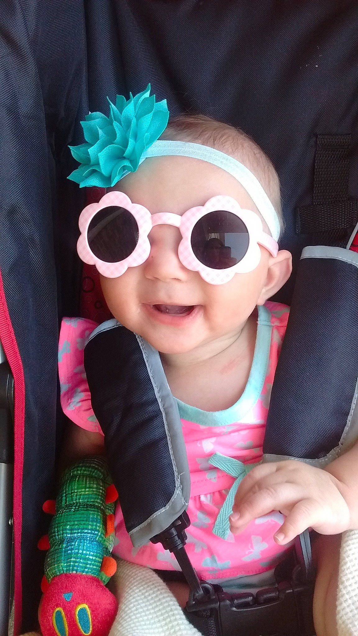 Izabella is registered to the contest to win money with this photo: baby_toddler_clothing, blue, cap, cool, eyelash, eyewear, finger, glasses, goggles, hand, happy, headwear, lip, magenta, person, personal_protective_equipment, pink, smile, sunglasses, thumb