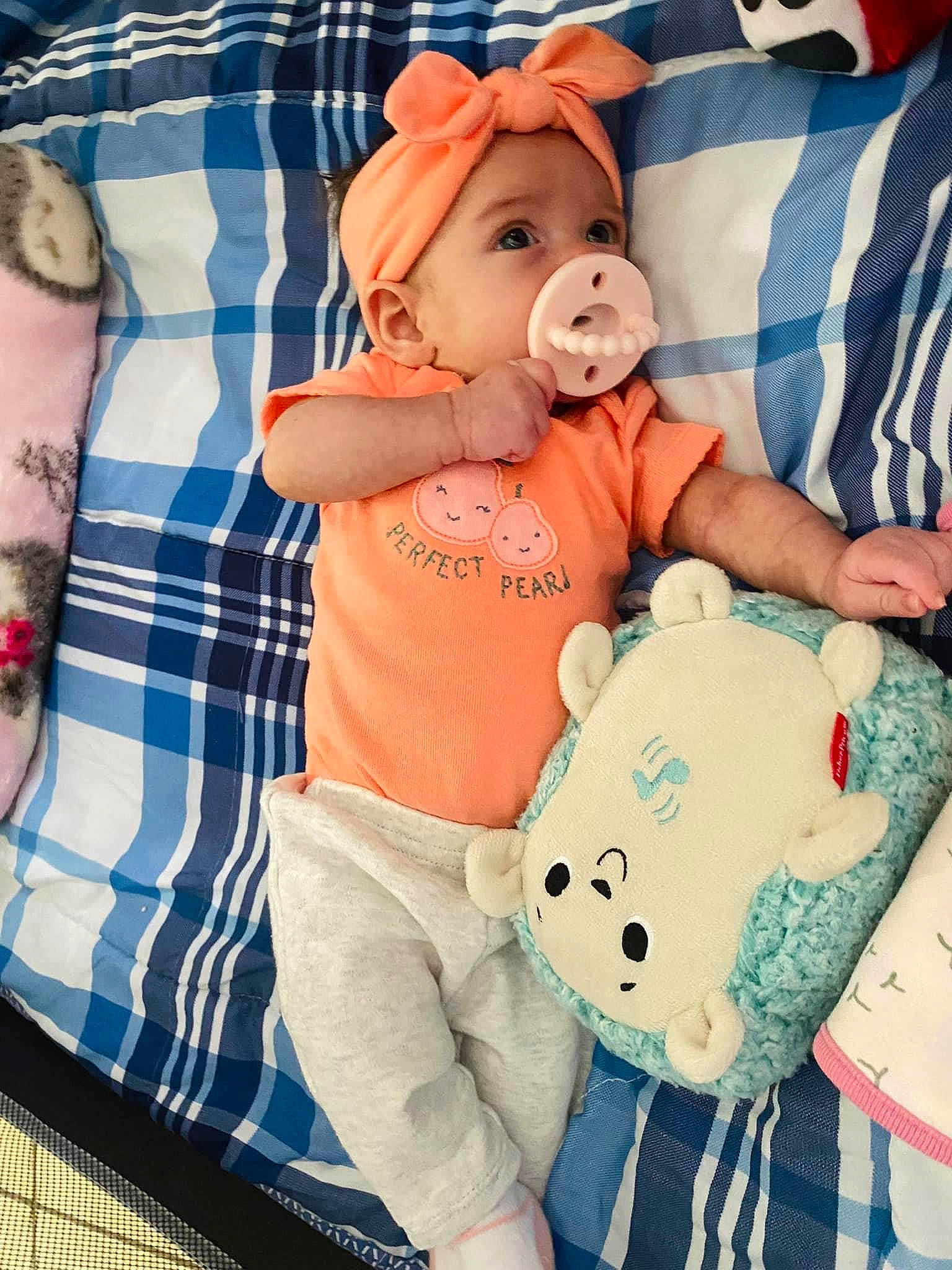 Malani is registered to the contest to win money with this photo: baby, baby_toddler_clothing, bag, blue, child, comfort, cool, happy, hat, headwear, linens, luggage_and_bags, pattern, person, pink, plaid, sleeve, t_shirt, tartan, textile