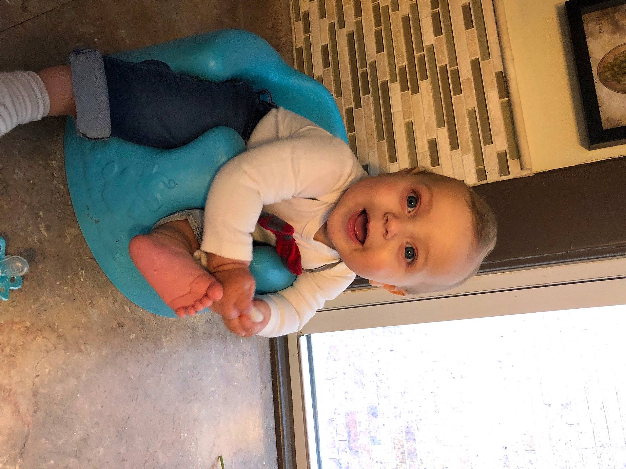 Landyn joined the competition — help win amazing prizes! baby, baby_toddler_clothing, blue, cheek, child, comfort, elbow, facial_expression, fun, happy, human, human_body, human_leg, mouth, person, sitting, skin, smile, toddler, window