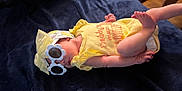 Giavanna is registered to the contest to win money with this photo: baby, sunglasses, yellow_clothing, headband, blanket, infant, sleeping, cute, child, fashion, accessory, foot, hand, indoor, soft_surface, apparel, resting, adorable, toddler, portrait