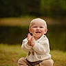 baby, child, smiling, clapping, outdoor, nature, wooden_crate, knitted_sweater, pants, happy, portrait, cute, sitting, grass, infant, warm_clothing, blond_hair, daylight, playful, fun