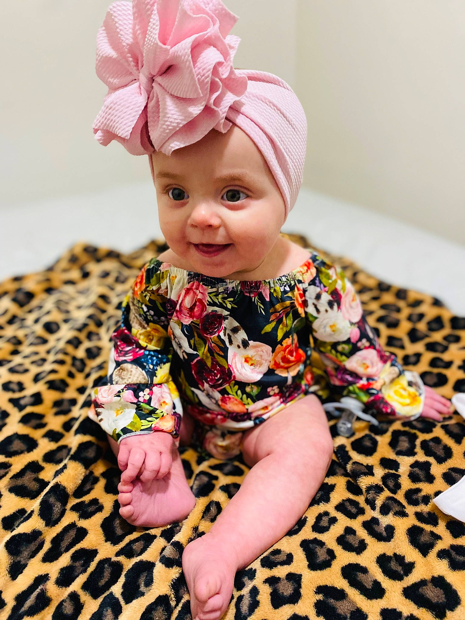 Layton joined the competition — help win amazing prizes! baby, baby_toddler_clothing, child, dress, fashion_accessory, flooring, foot, happy, headband, headpiece, headwear, human_leg, magenta, pattern, peach, person, pink, sitting, skin, sleeve