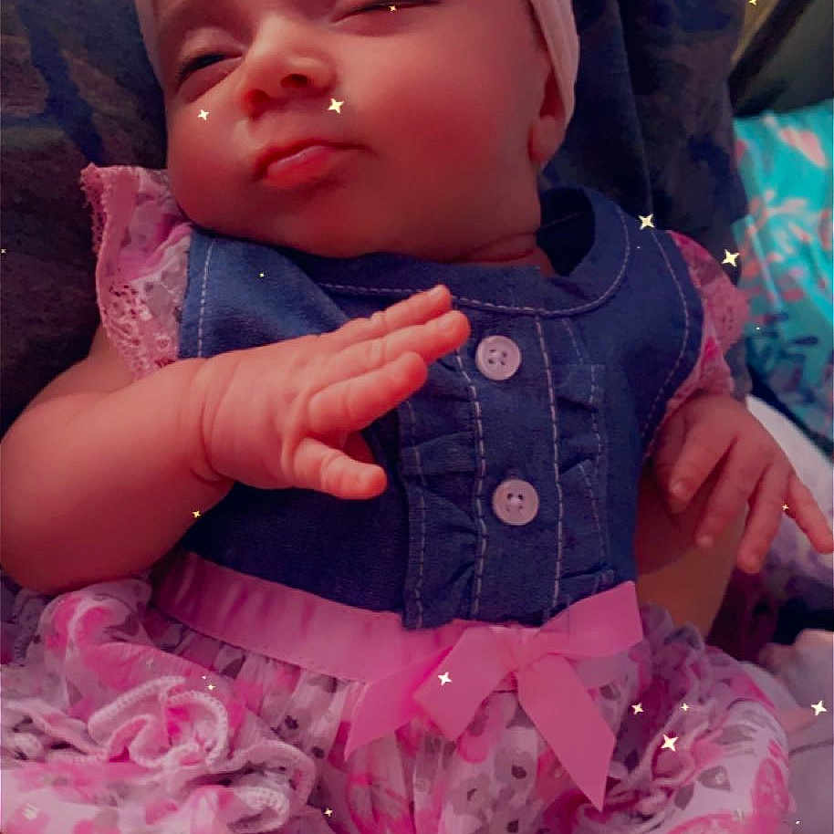 Heather is registered to the contest to win money with this photo: arm, baby, baby_toddler_clothing, blue, cheek, eye, face, facial_expression, finger, human_body, iris, lip, mouth, organ, pink, product, purple, skin, sleeve, white
