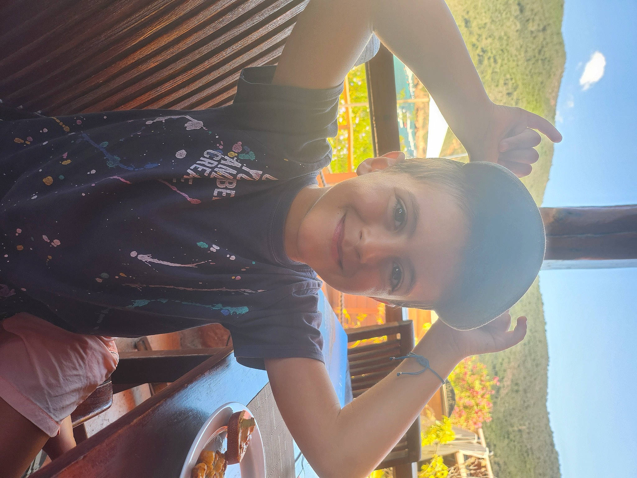 Lorenzo participe au concours pour gagner de l'argent avec cette photo : black_hair, elbow, eyewear, flash_photography, fun, gesture, grass, happy, joy, leisure, mouth, people_in_nature, person, sitting, sky, smile, t_shirt, tints_and_shades, toddler, tree