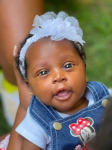 My'Kiah is registered to the contest to win money with this photo: baby_toddler_clothing, black_hair, cheek, child, eyebrow, eyelash, face, flash_photography, forehead, hair, happy, head, headband, headpiece, lip, nose, people, person, skin, toddler