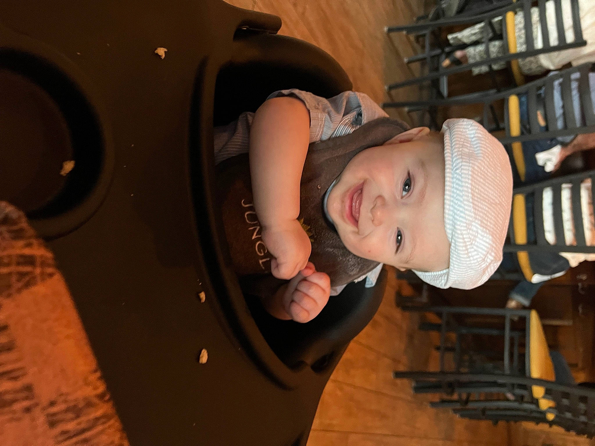 Chase is registered to the contest to win money with this photo: audio_equipment, auto_part, automotive_tire, baby, baby_toddler_clothing, bookcase, child, fashion_accessory, flash_photography, fun, hat, headwear, helmet, joy, machine, person, personal_protective_equipment, room, shelf, smile