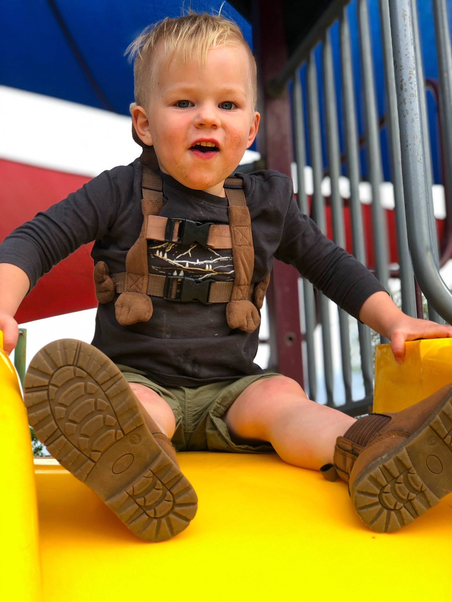 Kobi joined the competition — help win amazing prizes! baby, baby_toddler_clothing, blue, boot, electric_blue, finger, flooring, fun, happy, leisure, orange, outdoor_play_equipment, person, play, playground, recreation, sitting, smile, sneakers, toddler
