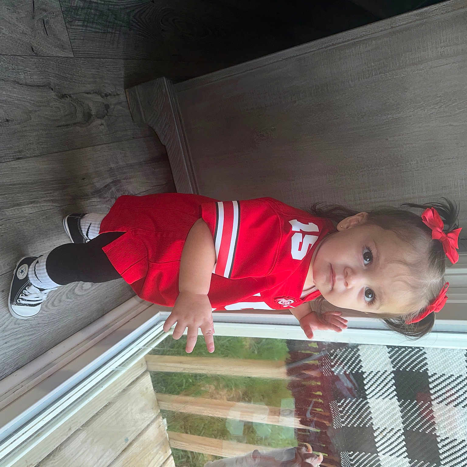 Elee is registered to the contest to win money with this photo: baby_toddler_clothing, carmine, child, composite_material, concrete, elbow, fun, hat, human_leg, outdoor_shoe, plant, sleeve, smile, t_shirt, toddler, walking_shoe, wood