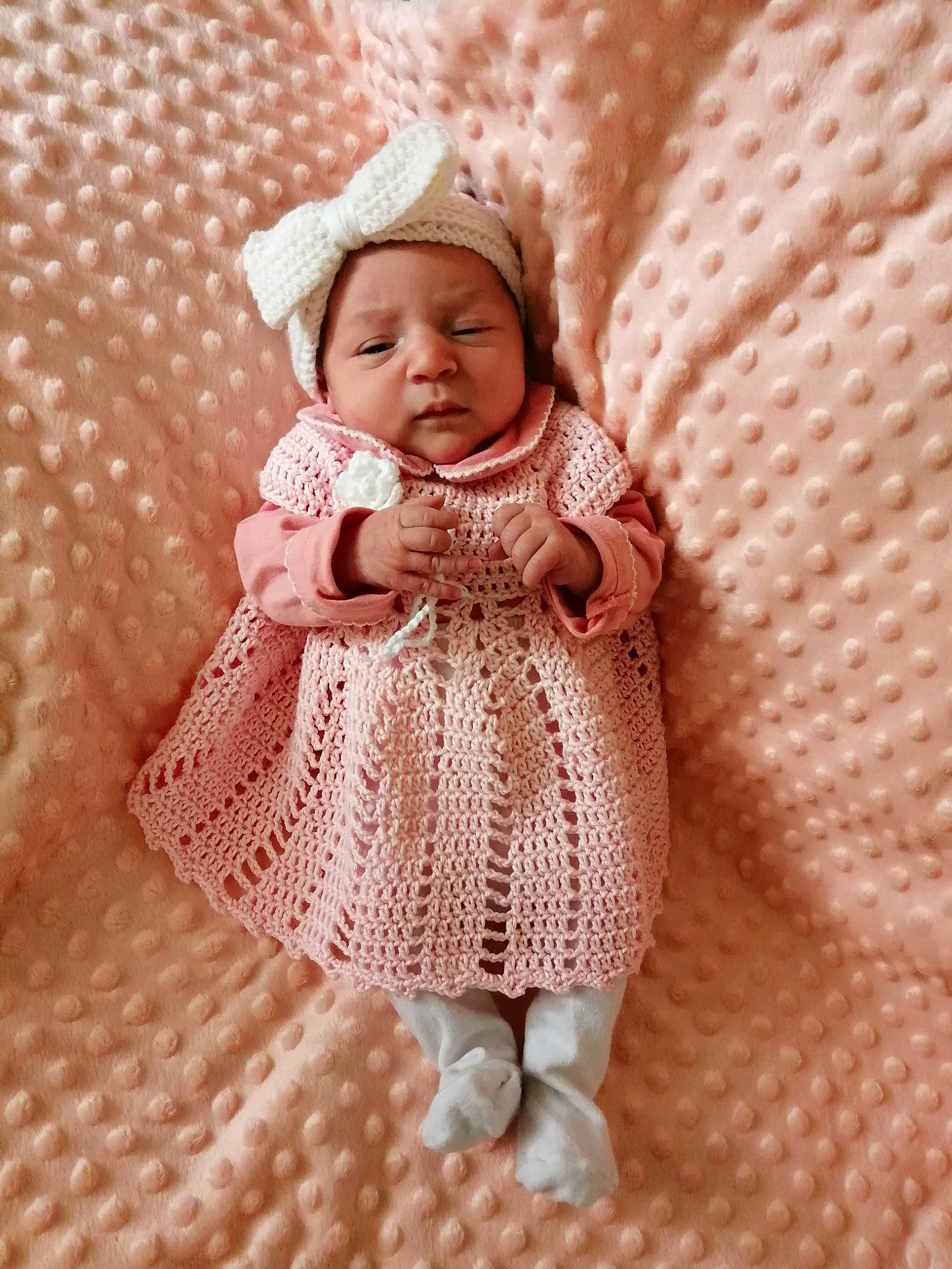 Lya participe au concours pour gagner de l'argent avec cette photo : baby, baby_toddler_clothing, cheek, child, dress, embellishment, face, headwear, linens, magenta, outerwear, pattern, peach, person, pink, skin, sleeve, sock, sun_hat, textile